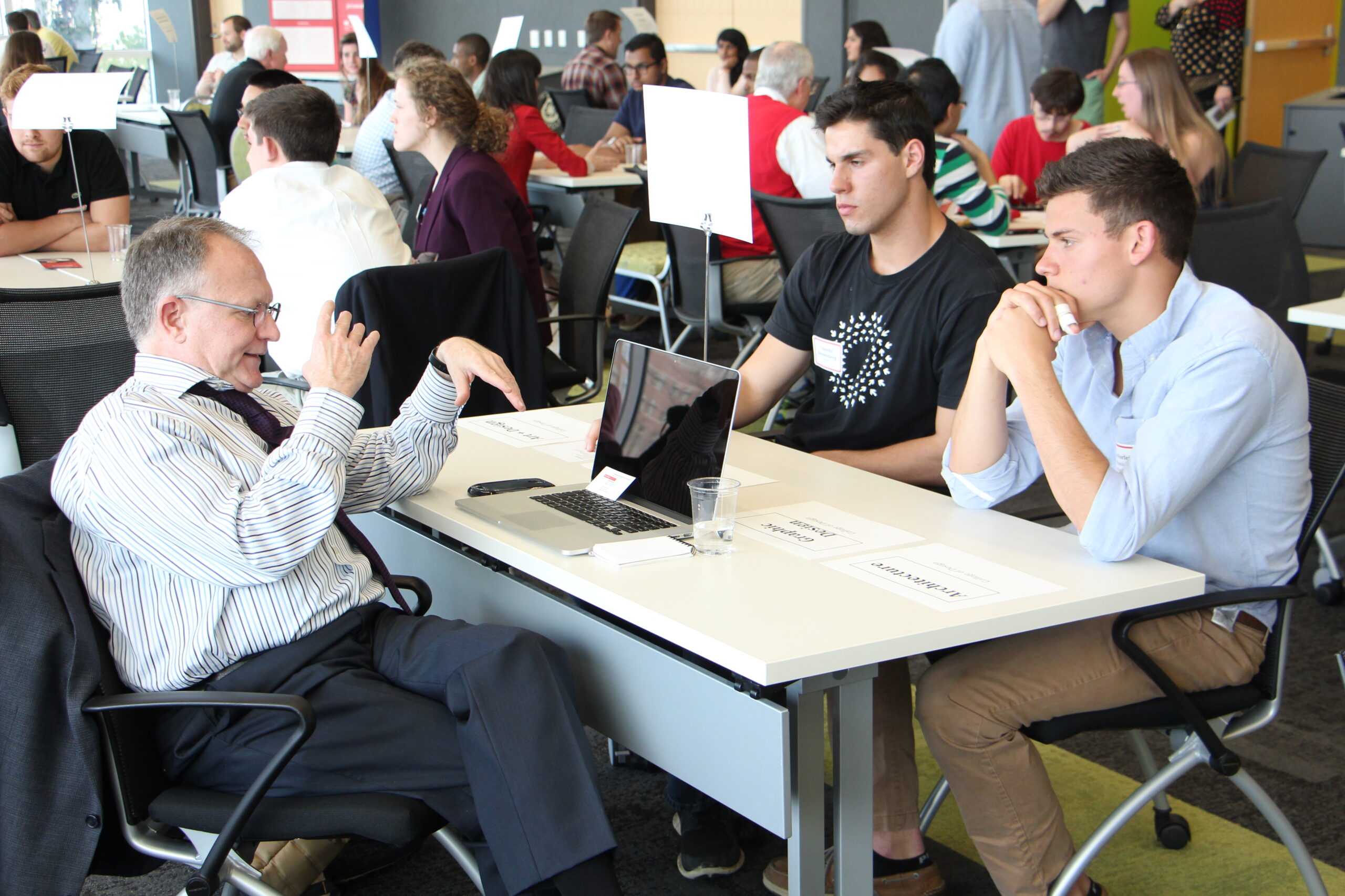 People talking around a desk.